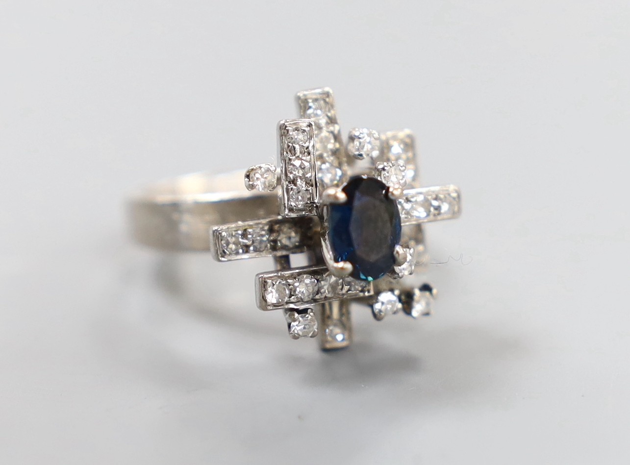 A modern 18k, sapphire and diamond cluster set dress ring, size K, gross weight 6 grams.